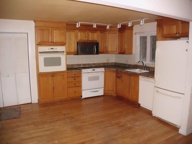 7 Coach Light Road Centerville, MA 02632 - Photo 3 of 22 a kitchen with stainless steel appliances granite countertop a refrigerator a stove and a sink