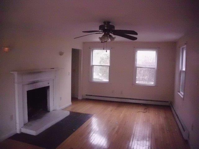 7 Coach Light Road Centerville, MA 02632 - Photo 4 of 22 a view of empty room with wooden floor and fireplace