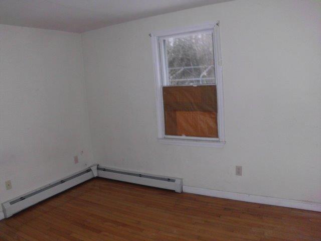 7 Coach Light Road Centerville, MA 02632 - Photo 6 of 22 a view of an empty room with wooden floor and a window