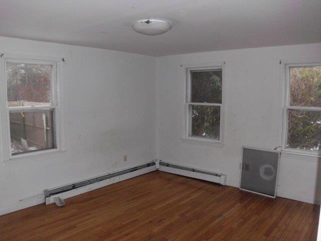 7 Coach Light Road Centerville, MA 02632 - Photo 8 of 22 an empty room with wooden floor and windows