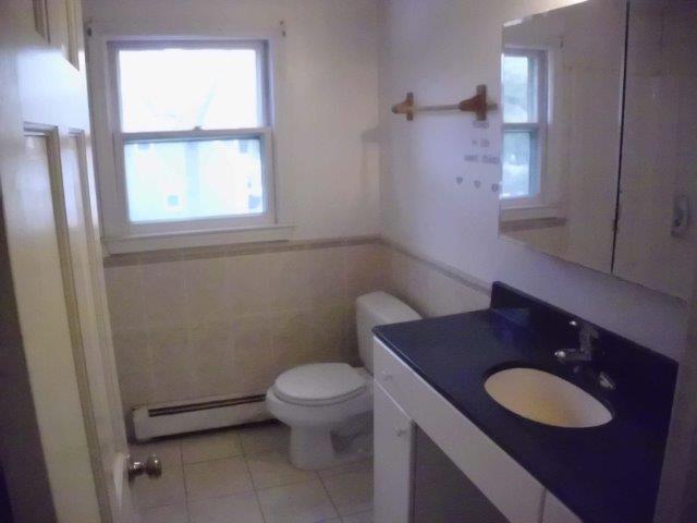 7 Coach Light Road Centerville, MA 02632 - Photo 10 of 22 a bathroom with a granite countertop toilet a sink and a mirror