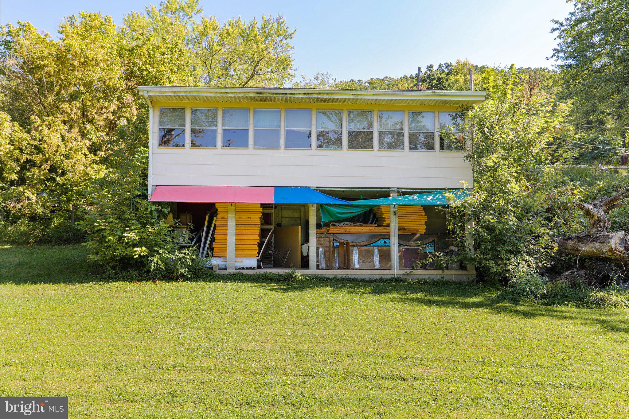 13726 Hopps Landing Road Hagerstown, MD 21740 - Photo 14 of 28 a view of a large pool with lawn chairs under an umbrella