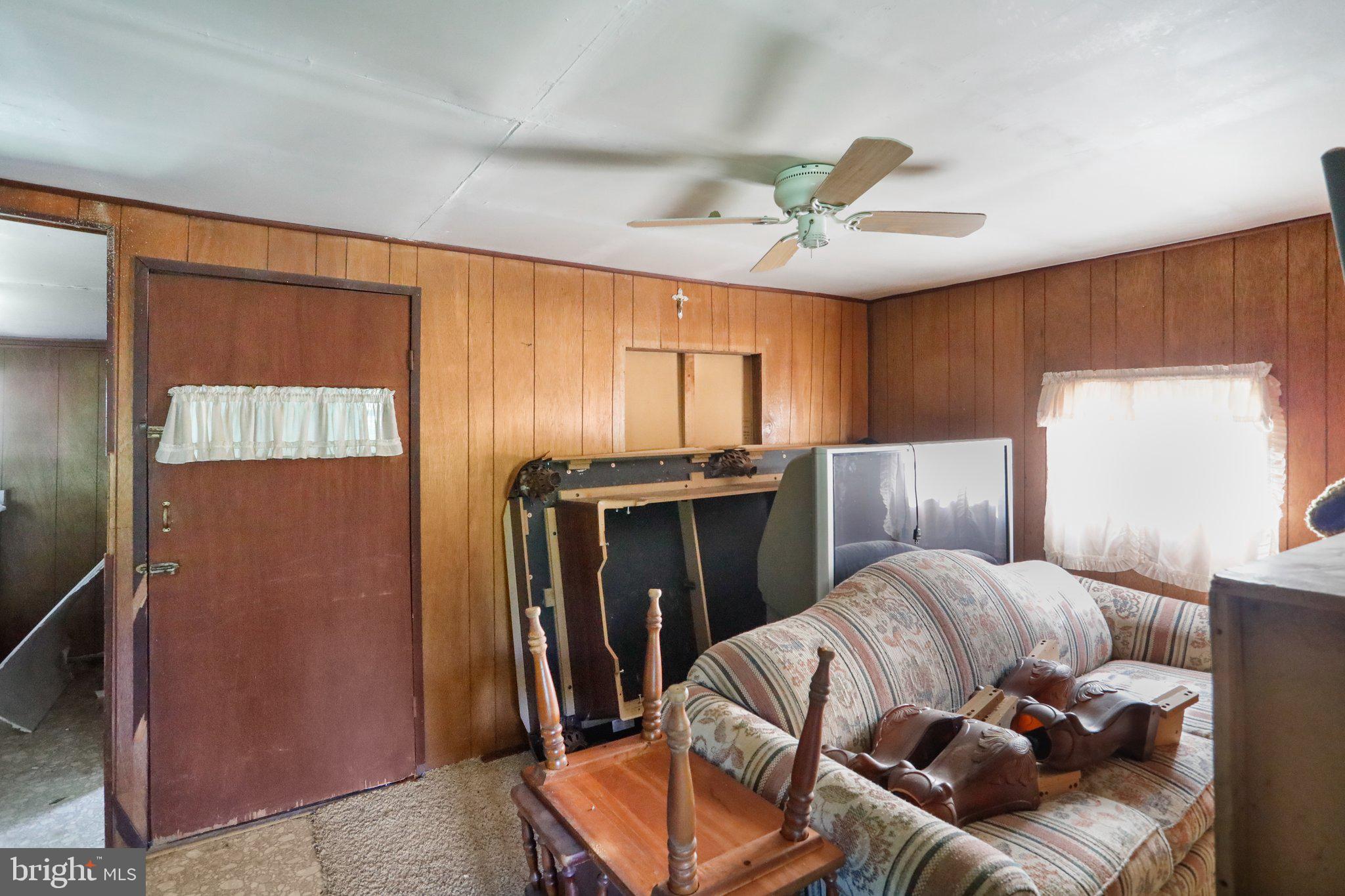 13726 Hopps Landing Road Hagerstown, MD 21740 - Photo 9 of 28 a living room with furniture a ceiling fan and a window