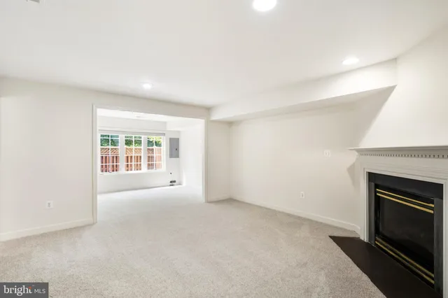 an empty room with a fireplace and a sink