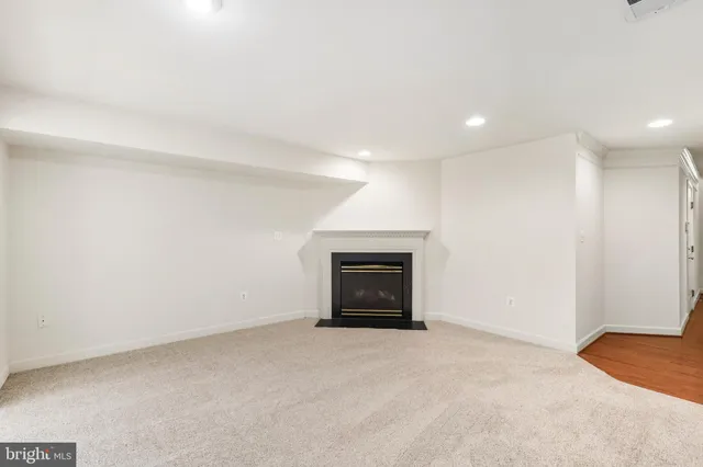 a view of an empty room with a fireplace