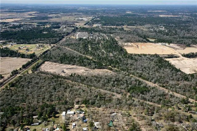 an aerial view of residential house and covered with trees
