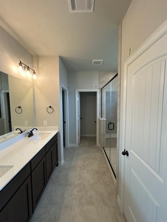 8779 County Road 623 Blue Ridge, TX 75424 - Photo 8 of 12 a bathroom with a double vanity sink mirror and shower
