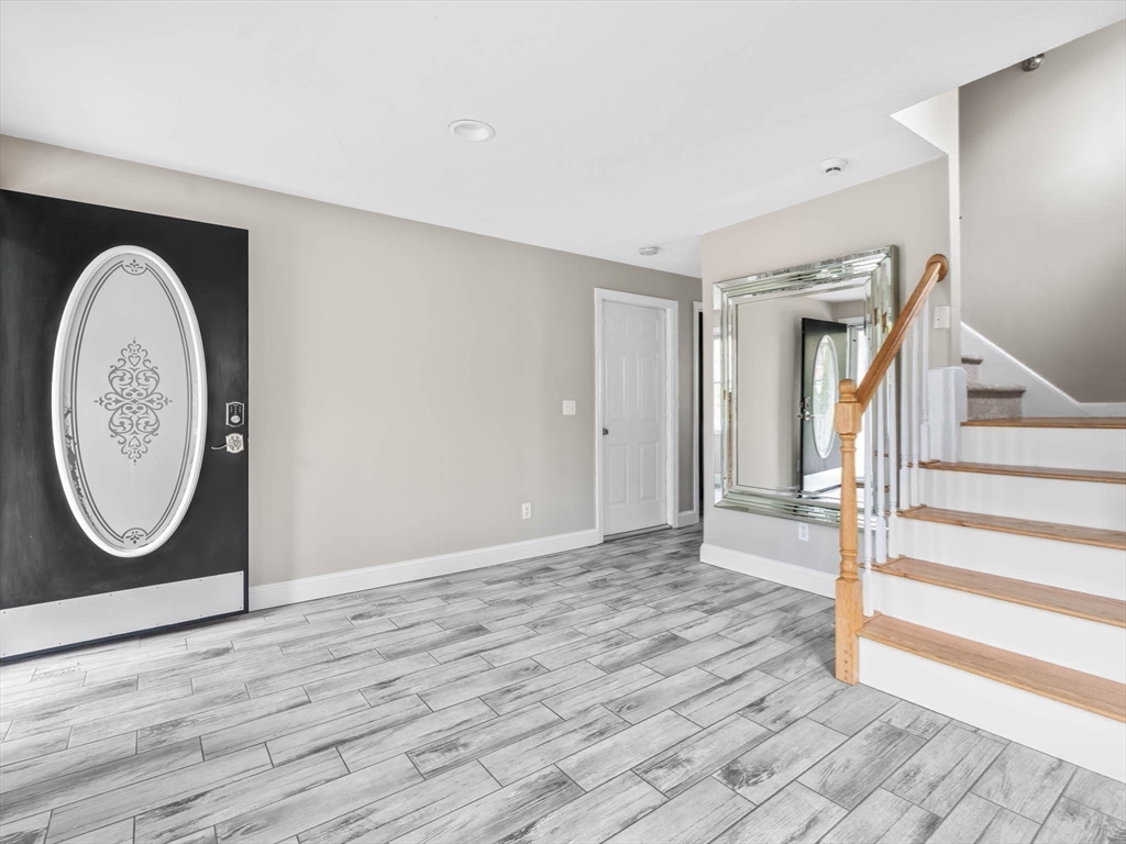 20 Angela Rose Lane Worcester, MA 01604 - Photo 11 of 35 a view of a livingroom with wooden floor and a large window