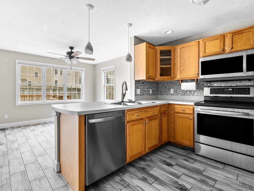 20 Angela Rose Lane Worcester, MA 01604 - Photo 15 of 35 a kitchen with stainless steel appliances granite countertop a stove and a sink