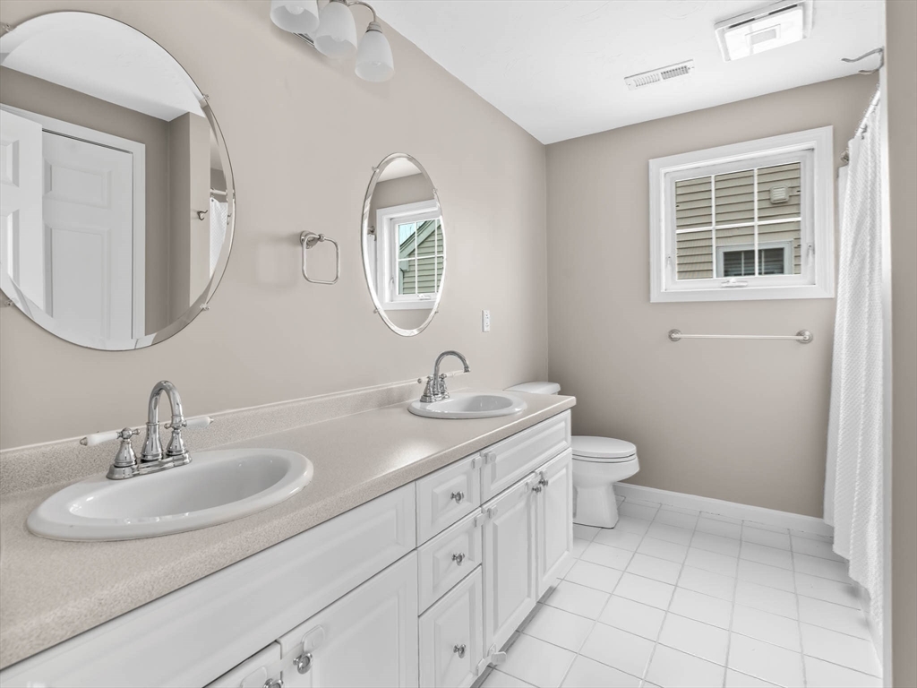 20 Angela Rose Lane Worcester, MA 01604 - Photo 26 of 35 a bathroom with a toilet sink and mirror