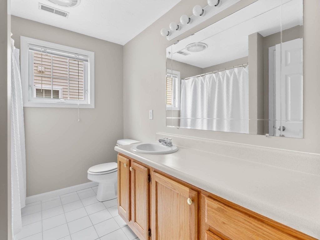 20 Angela Rose Lane Worcester, MA 01604 - Photo 28 of 35 a bathroom with a granite countertop sink a toilet and a window