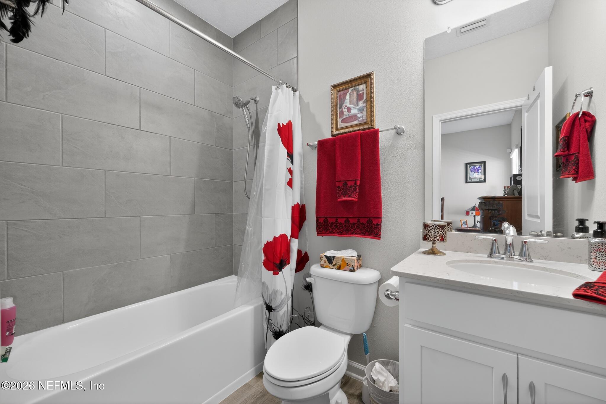 75505 Banyan Way Yulee, FL 32097 - Photo 20 of 30 a bathroom with a toilet sink vanity tub and shower