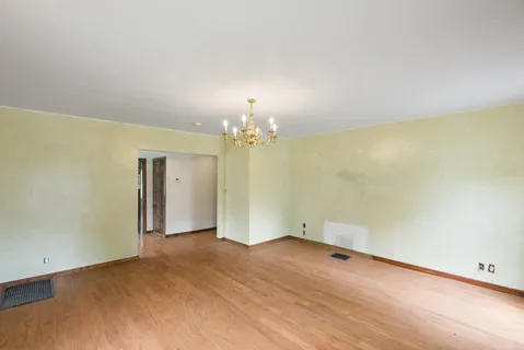 a view of a livingroom with a window and wooden floor