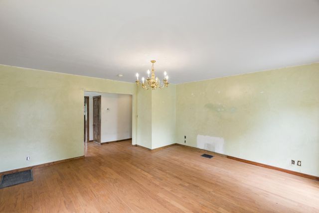 a view of a livingroom with a window and wooden floor