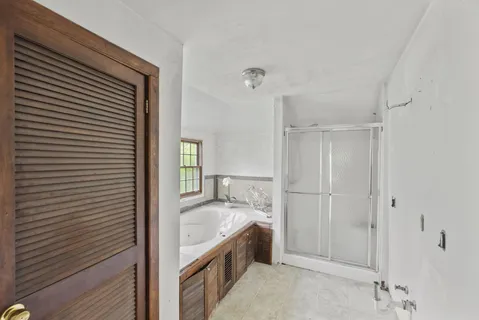 a bathroom with a bathtub and a window