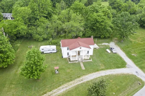 an aerial view of a house with a yard