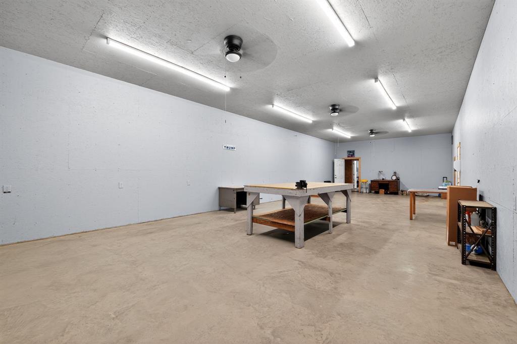 5485 Highway 7 Marlin, TX 76661 - Photo 32 of 36 Rec room with ceiling fan, concrete flooring, a textured ceiling, and a workshop area