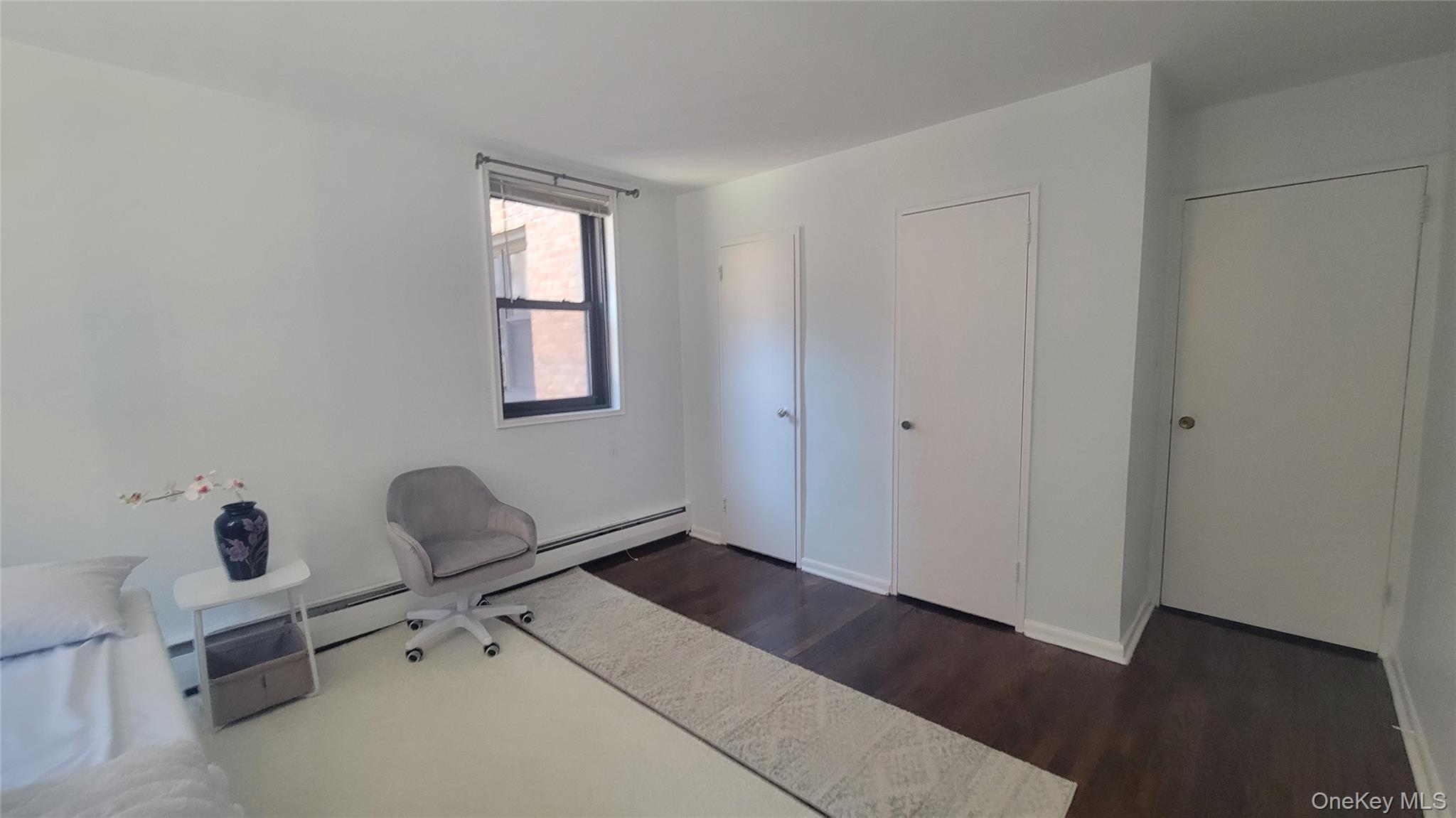99-06 58th Avenue, Unit 2F Queens, NY 11368 - Photo 12 of 24 a room with windows and closet