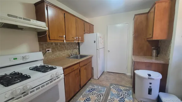 a kitchen with sink cabinets and appliances