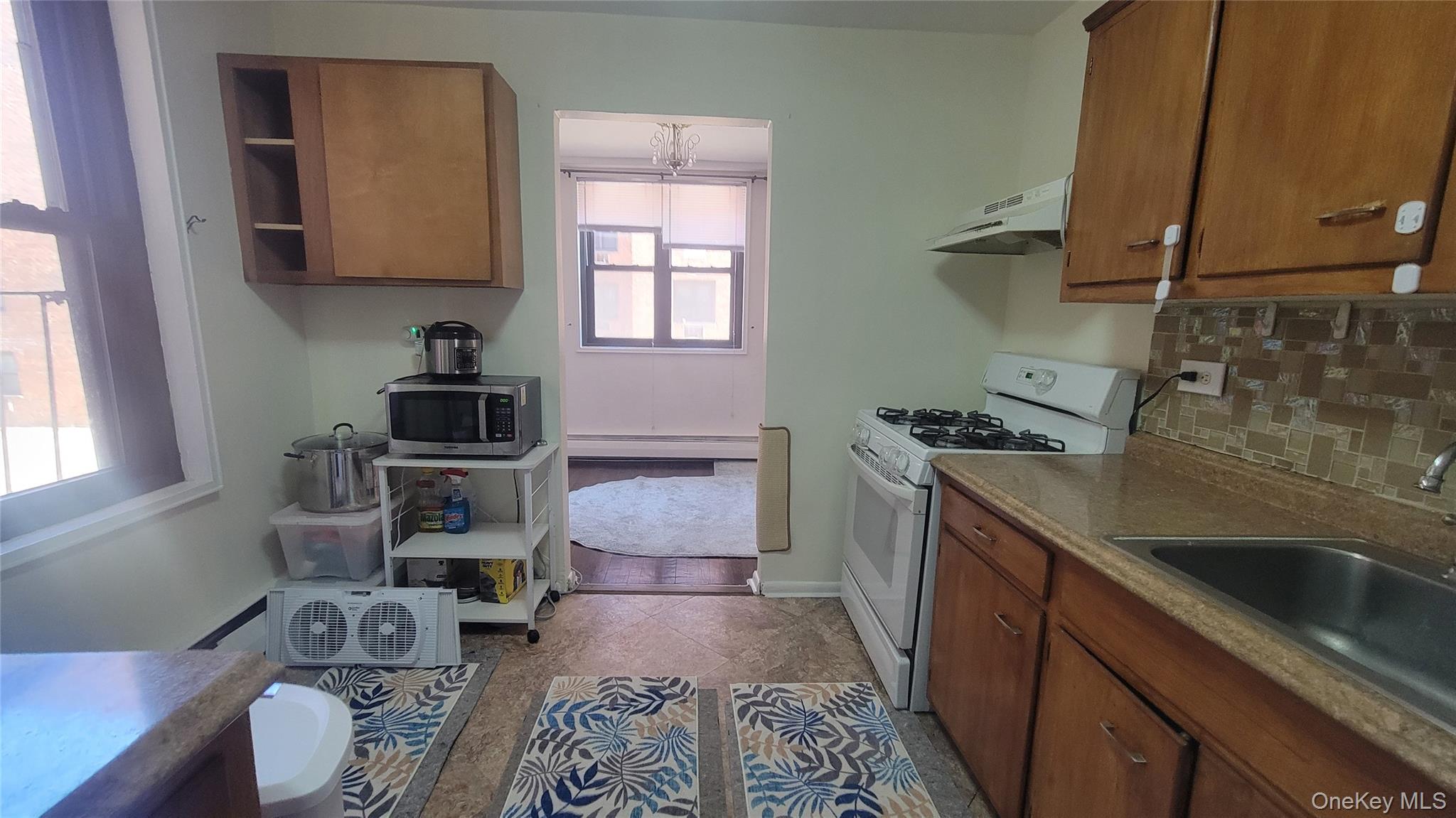 99-06 58th Avenue, Unit 2F Queens, NY 11368 - Photo 17 of 24 a kitchen with sink cabinets and appliances
