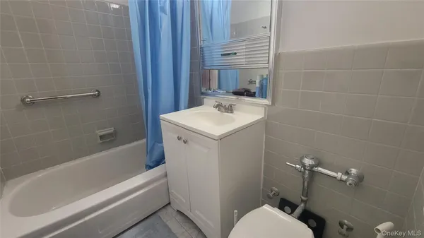 a bathroom with a sink a toilet and bathtub