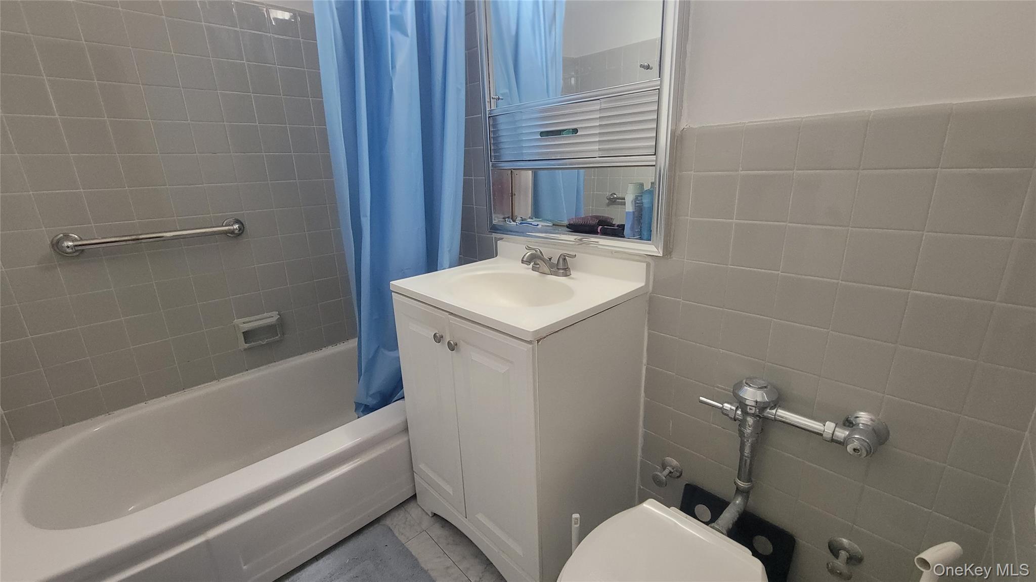 99-06 58th Avenue, Unit 2F Queens, NY 11368 - Photo 18 of 24 a bathroom with a sink toilet and shower