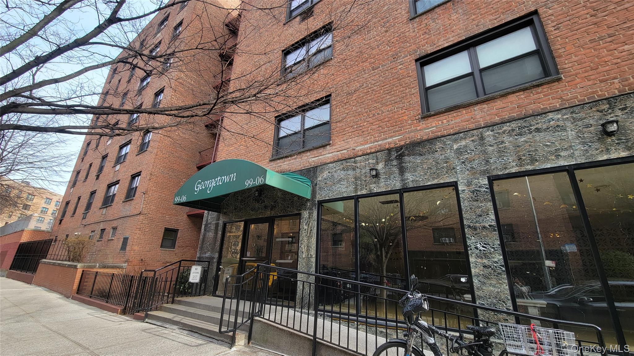 99-06 58th Avenue, Unit 2F Queens, NY 11368 - Photo 2 of 24 a view of a building with a glass door