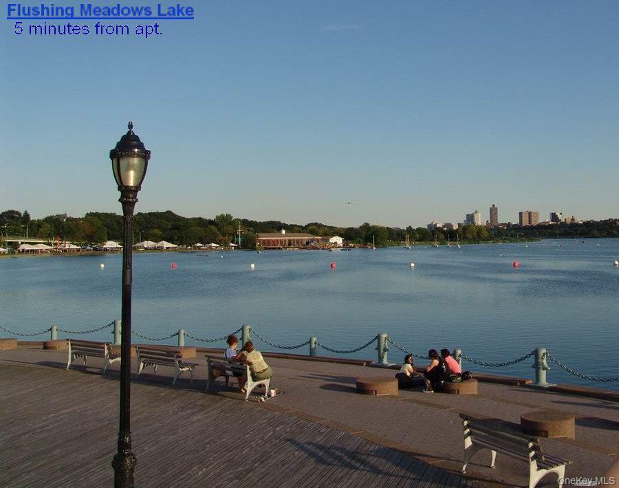 99-06 58th Avenue, Unit 2F Queens, NY 11368 - Photo 24 of 24 a lake view with a bench under an ocean view