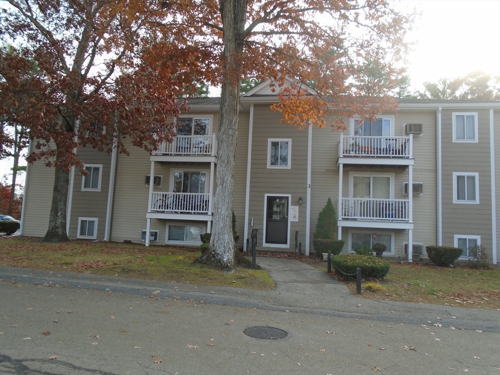 a front view of a house with glass windows and yard
