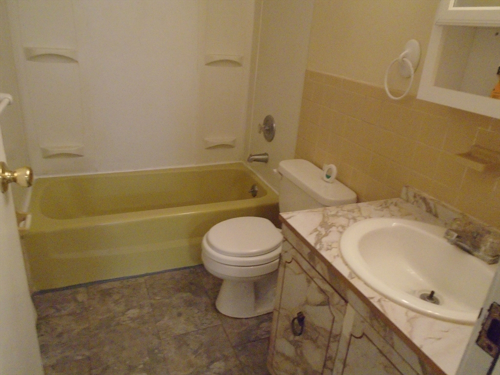 451 School Street, Unit 34 Marshfield, MA 02050 - Photo 14 of 18 a bathroom with a sink a toilet and bathtub