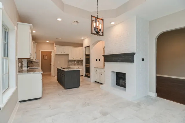 a kitchen with stainless steel appliances granite countertop a sink stove and microwave