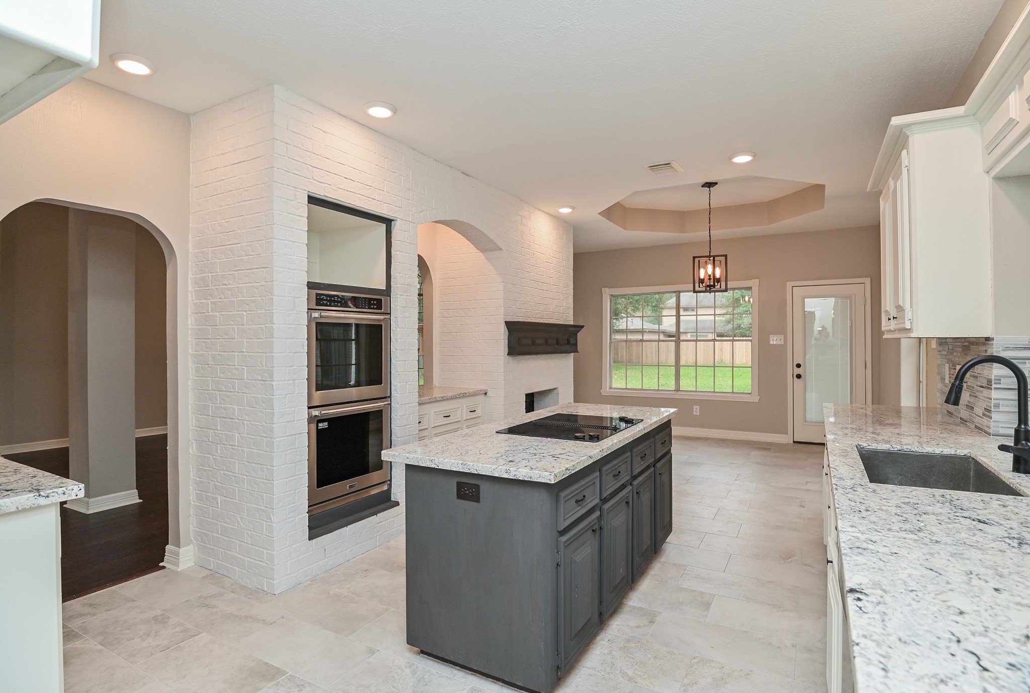 17910 Moss Point Drive Spring, TX 77379 - Photo 13 of 32 a kitchen with kitchen island granite countertop a sink stove and refrigerator