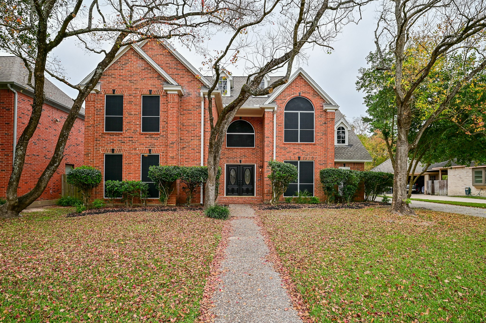 17910 Moss Point Drive Spring, TX 77379 - Photo 2 of 32 a front view of a house with yard and trees