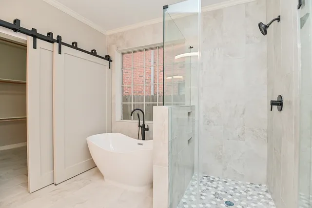 a bathroom with a double vanity sink a toilet and shower