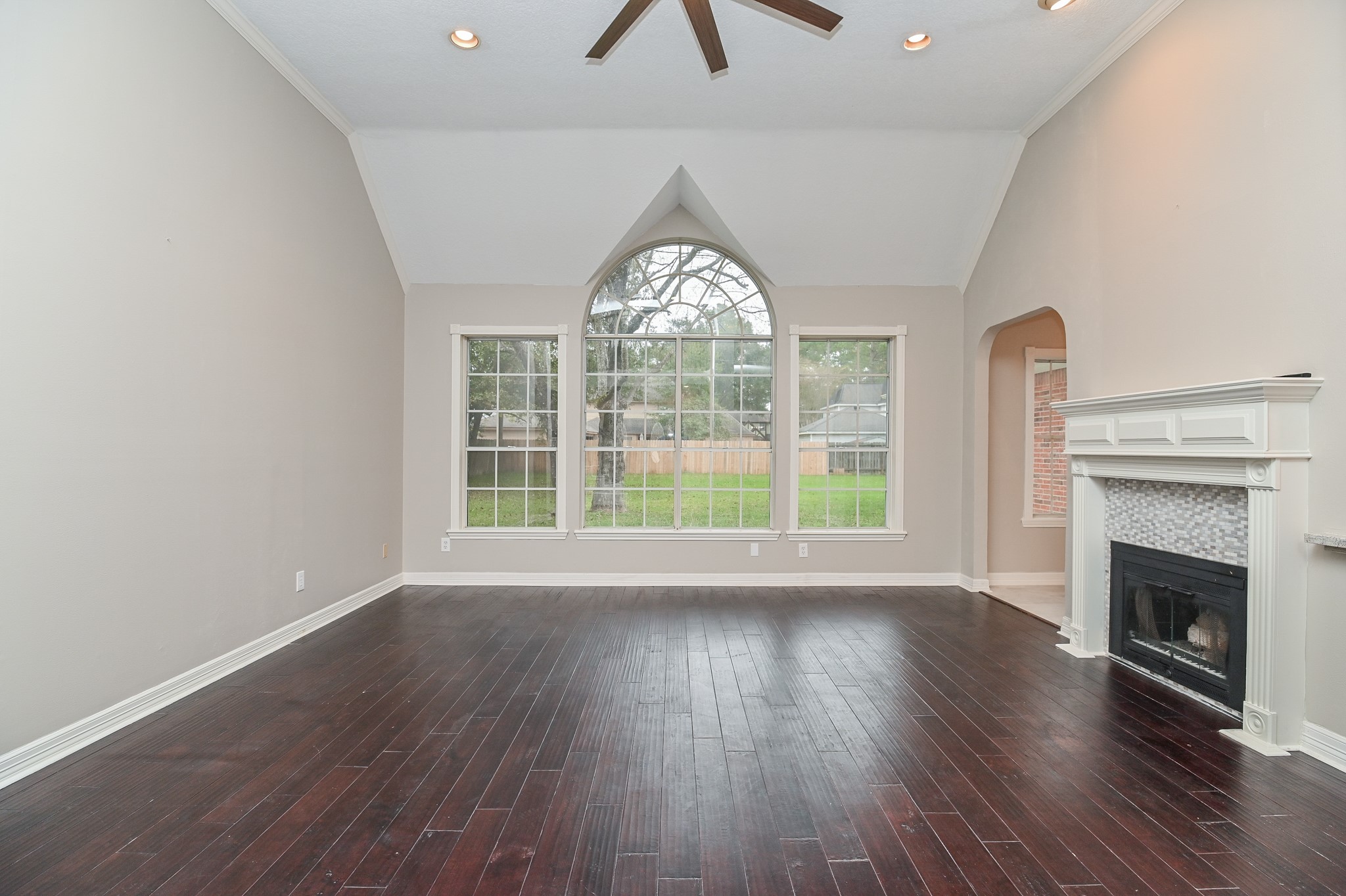 17910 Moss Point Drive Spring, TX 77379 - Photo 6 of 32 an empty room with wooden floor fireplace and windows