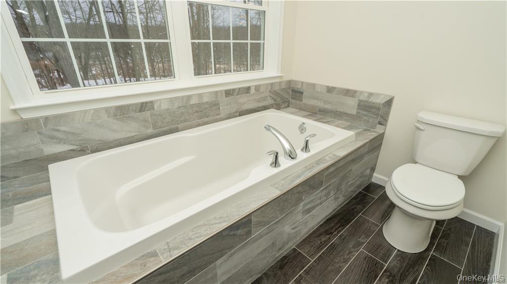 5 Harrier Ridge Drive Wallkill, NY 12589 - Photo 17 of 33 Bathroom featuring a bath and baseboards