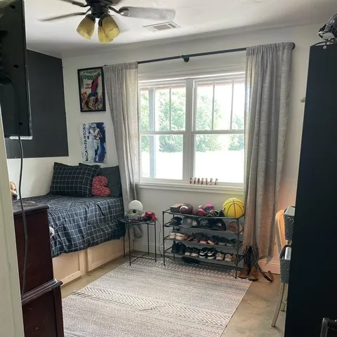 a bedroom with furniture and a window