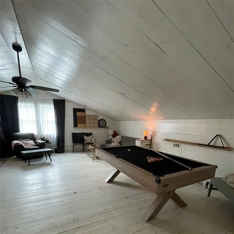 a living room with furniture a window and gym equipment