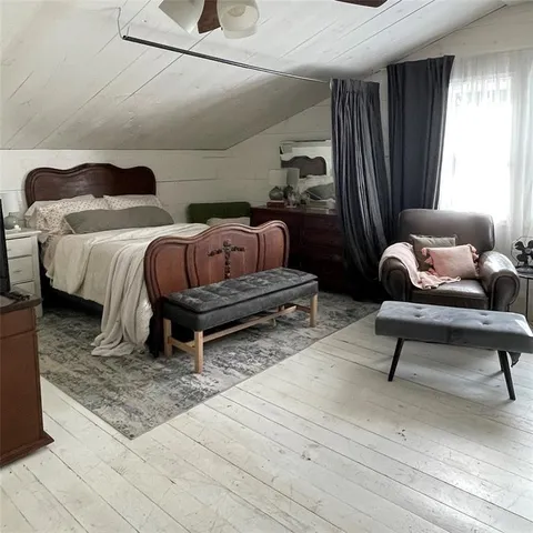 a bedroom with a bed and window