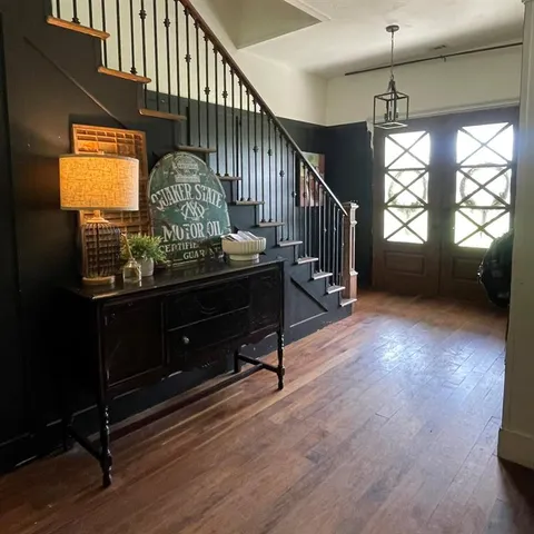 a view of entryway and hall with wooden floor
