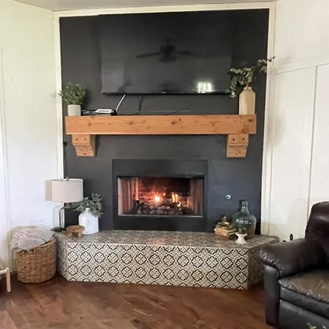 a living room with furniture a fireplace and a fireplace