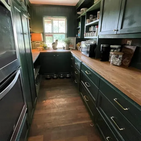 a kitchen with stainless steel appliances granite countertop a refrigerator a sink dishwasher stove and cabinets