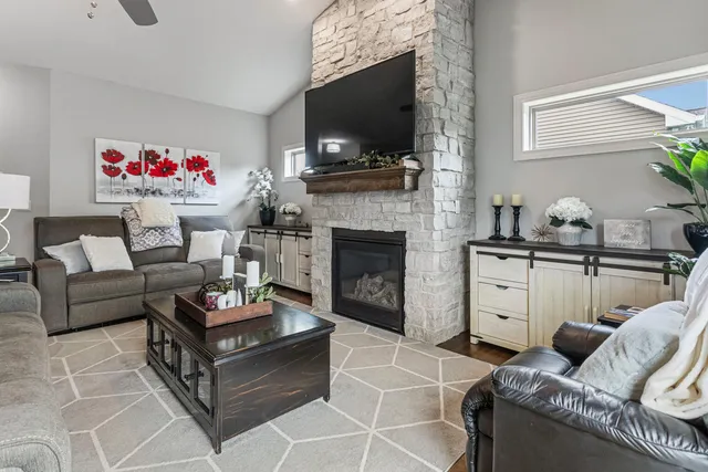 a living room with furniture a flat screen tv and a fireplace