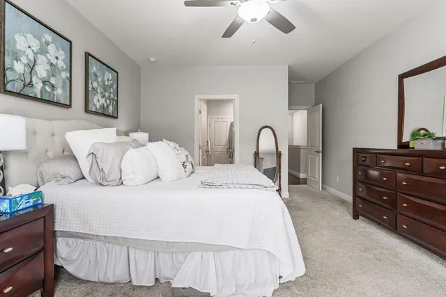 a spacious bathroom with a double vanity sink a large mirror a bathtub and shower