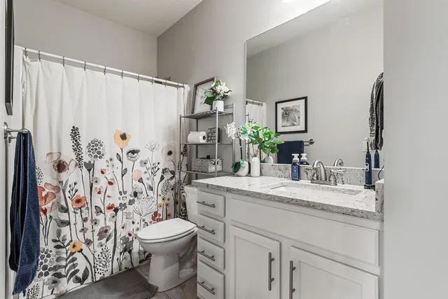 a view of a backyard with table and chairs with wooden fence