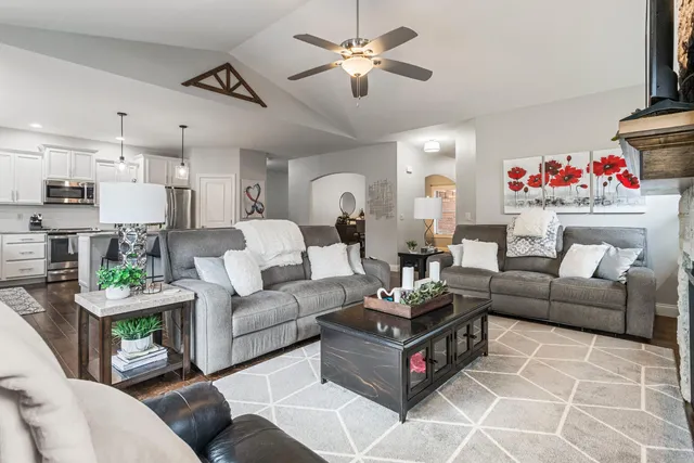 a living room with furniture and a chandelier