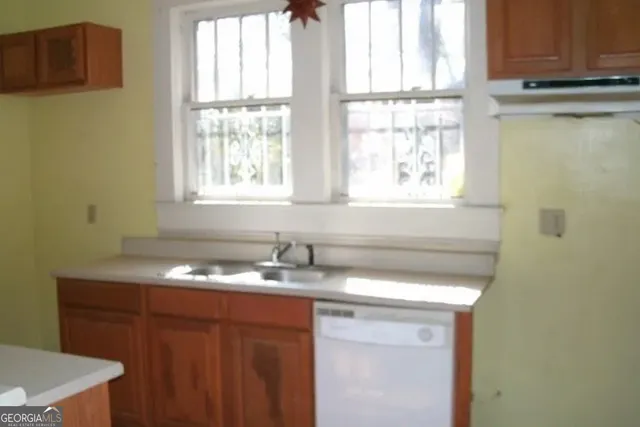 a bathroom with a sink a vanity and a window
