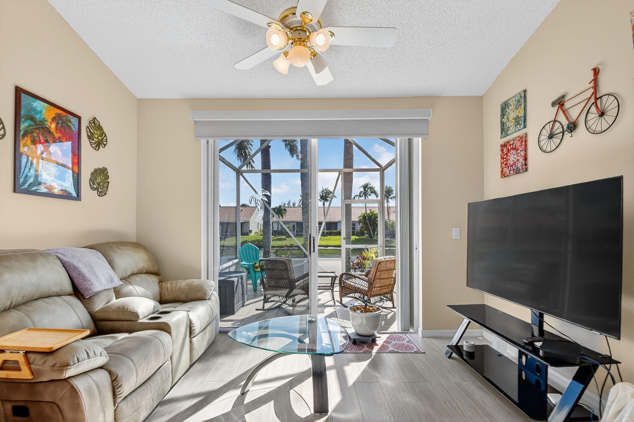 6210 Heliconia Road Delray Beach, FL 33484 - Photo 25 of 53 a living room with furniture a flat screen tv and a large window