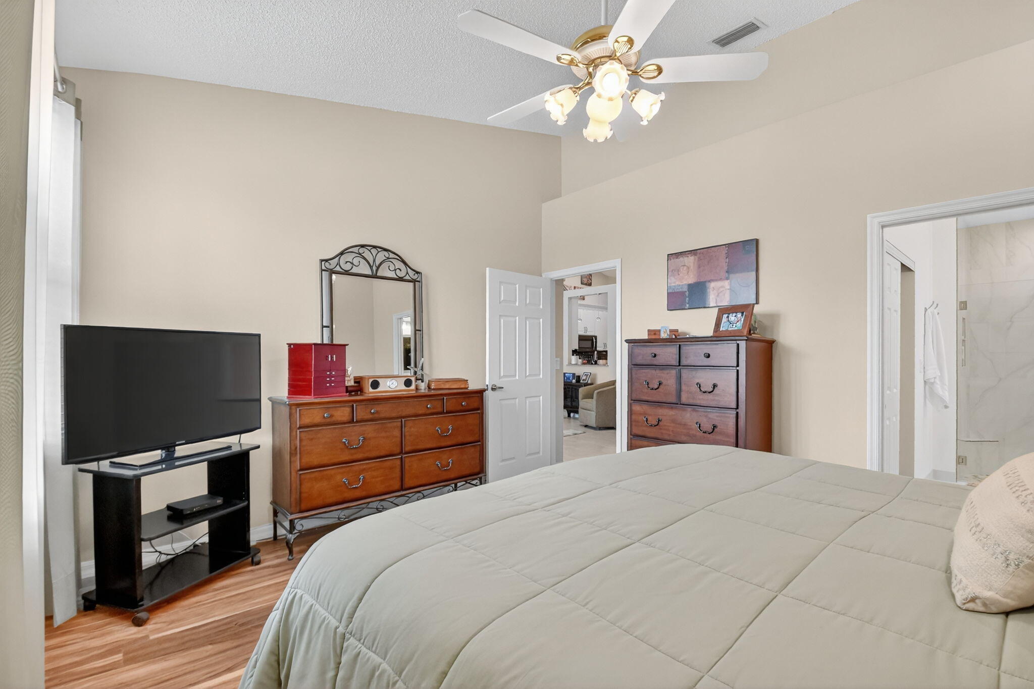 6210 Heliconia Road Delray Beach, FL 33484 - Photo 32 of 53 a bedroom with a bed and a flat screen tv