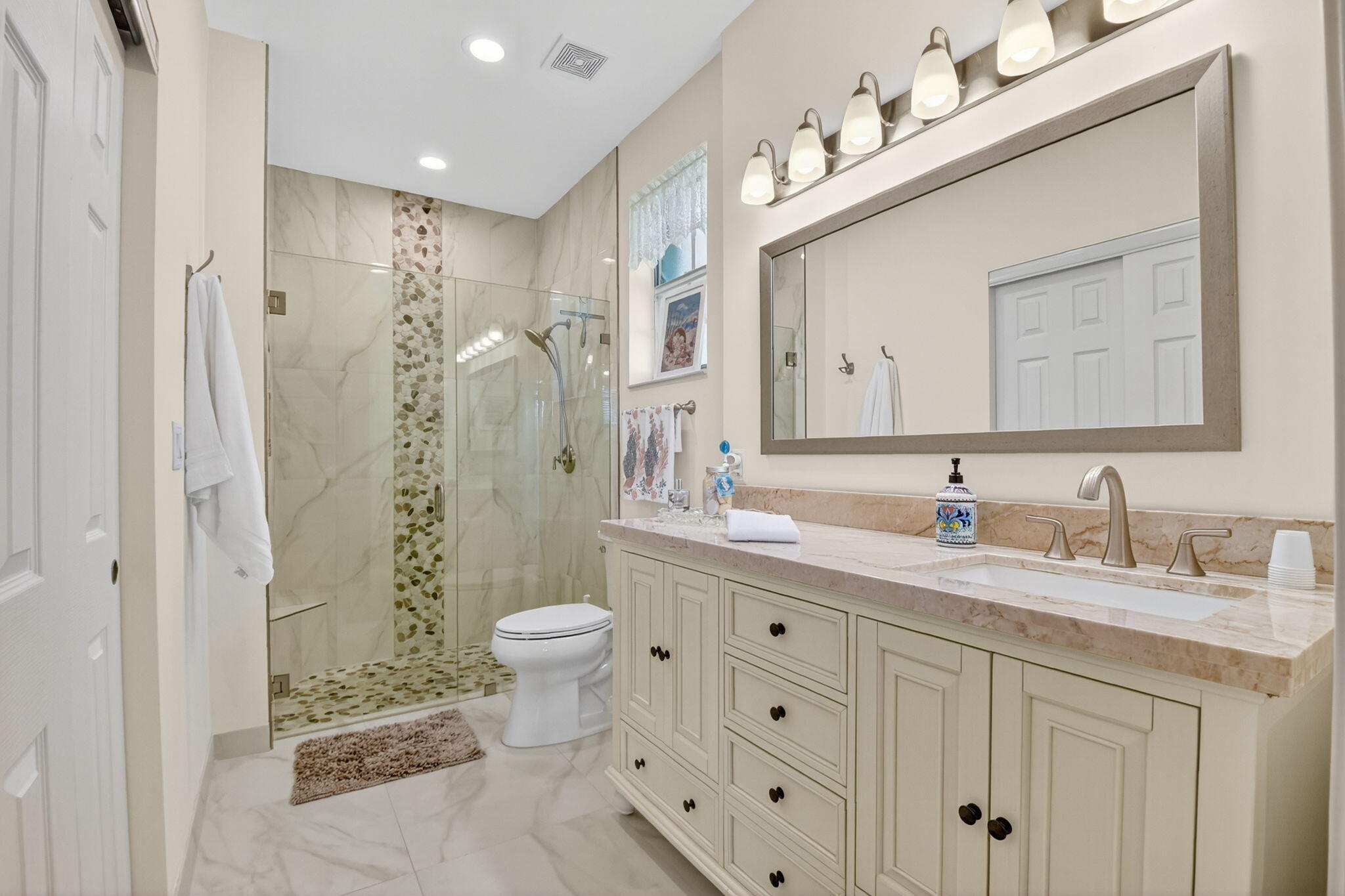 6210 Heliconia Road Delray Beach, FL 33484 - Photo 33 of 53 a bathroom with a granite countertop sink toilet a large mirror a shower and a